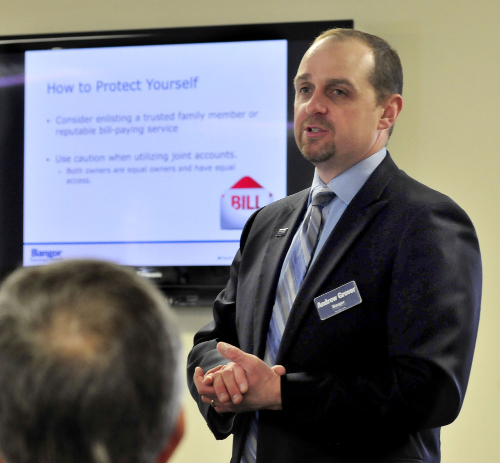 Andrew Grover, a risk officer at Bangor Savings Bank, offers advice on how to protect one's identity and money Tuesday during a seminar at China Baptist Church in China.