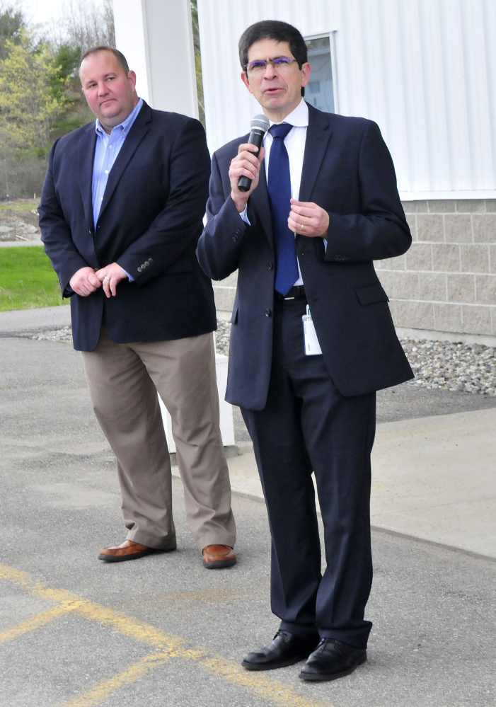 Milson Gondim, right, Elanco vice president of global vaccine manufacturing, speaks to employees Wednesday during the opening of the company's new autogenous poultry vaccine facility in Winslow. At left is sales manager Tim Hopson.