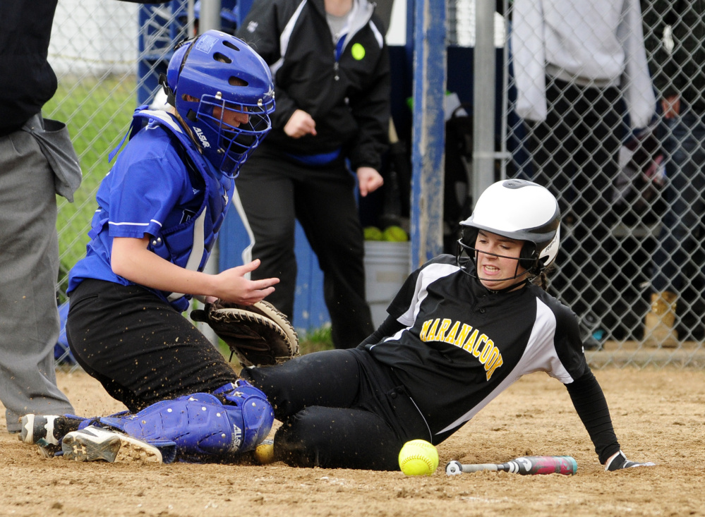 Erskine catcher Taylor McLaggan, left, looses the ball as Maranacook's Faith Jacques scores Wednesday in South China.