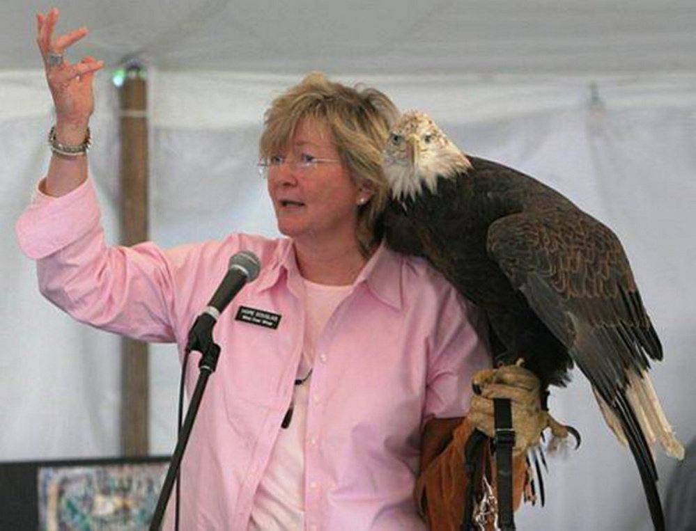 Hope Douglas, holding a bald eagle.