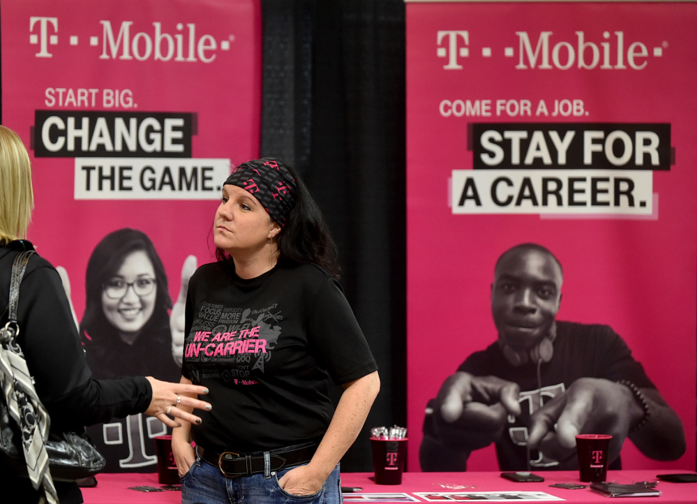 Tonya Clark, a recruiter from T-Mobile, speaks with a prospective employee Friday at the Growth Council job fair at the T&B Celebration Center in Waterville.