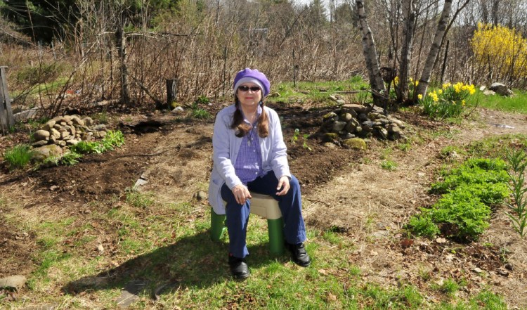 Author and mystic Annie Stillwater Gray finds solace in her vegetable and flower garden Thursday at her home in Solon.