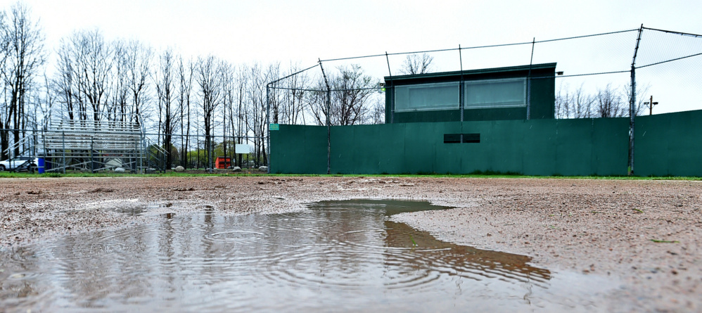 Mud and a puddle occupy home plate on the baseball field at Winslow High School.