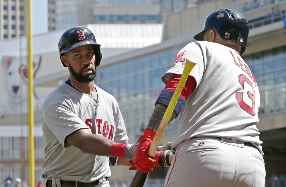Boston's Chris Young, left, is congratulated by Sandy Leon after hitting a home run off Minnesota Twins pitcher Drew Rucinski in the fifth inning Saturday in Minneapolis. Young also homered in the second inning.