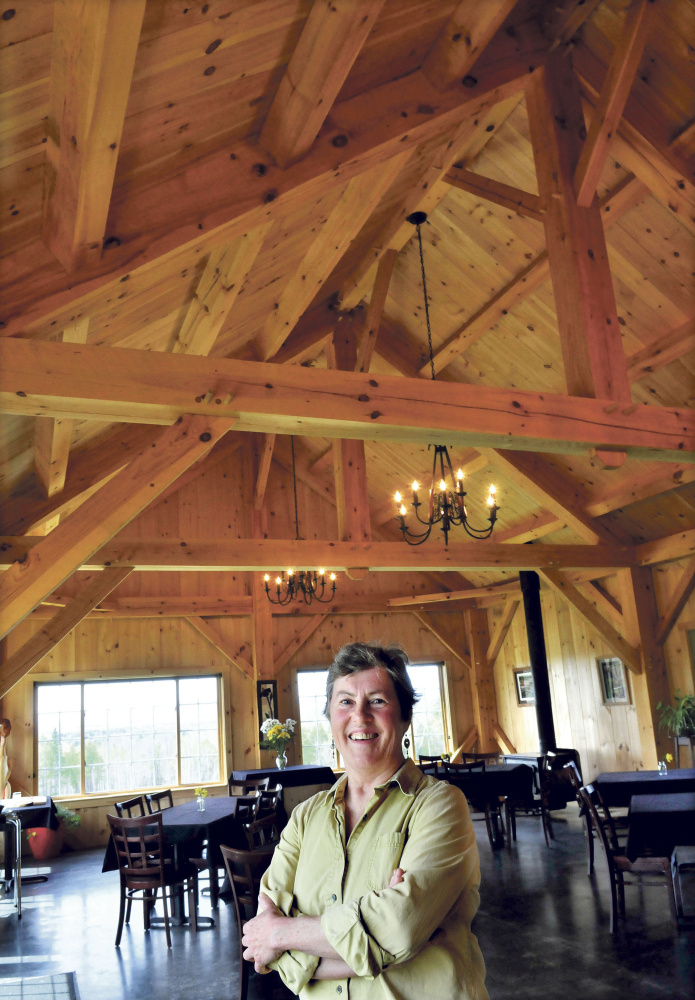 Mary Burr speaks Thursday inside her timber framed restaurant 122 Corson, the same as its address in Mercer. The restaurant features locally grown and raised meats and vegetables complete with fancy desserts and alcoholic beverages in a country setting.