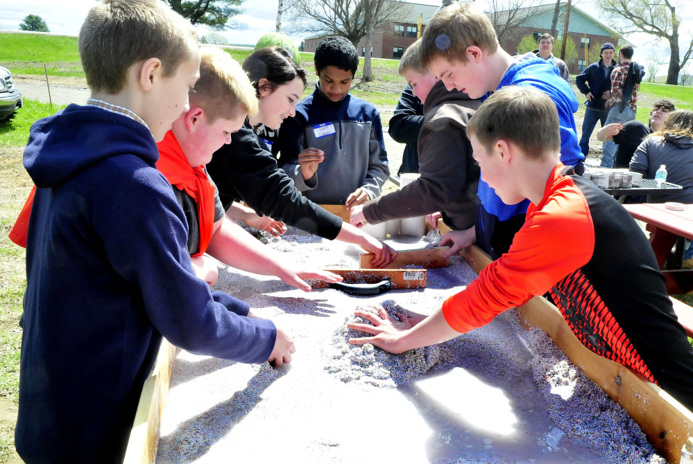 Skowhegan Middle School students explore a water erosion demonstration station at the Marti Stevens Learning Center in Skowhegan during a forest field day on Wednesday.