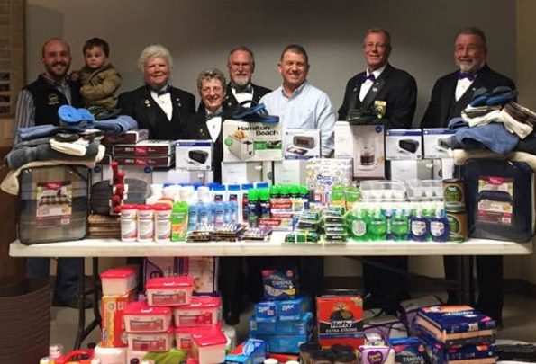 Waterville Elks Lodge 905 recently assisted the Mid Maine Homeless Shelter with a large donation of goods to help with the day-to-day operations of the shelter. Officers, from left, are Nick Champagne, holding Owen Champagne; Sandi Anderson, Felicia Gaulin, Dave Hammond, Board of Directors member Brian Watson,  Don Young and Dave Anderson.