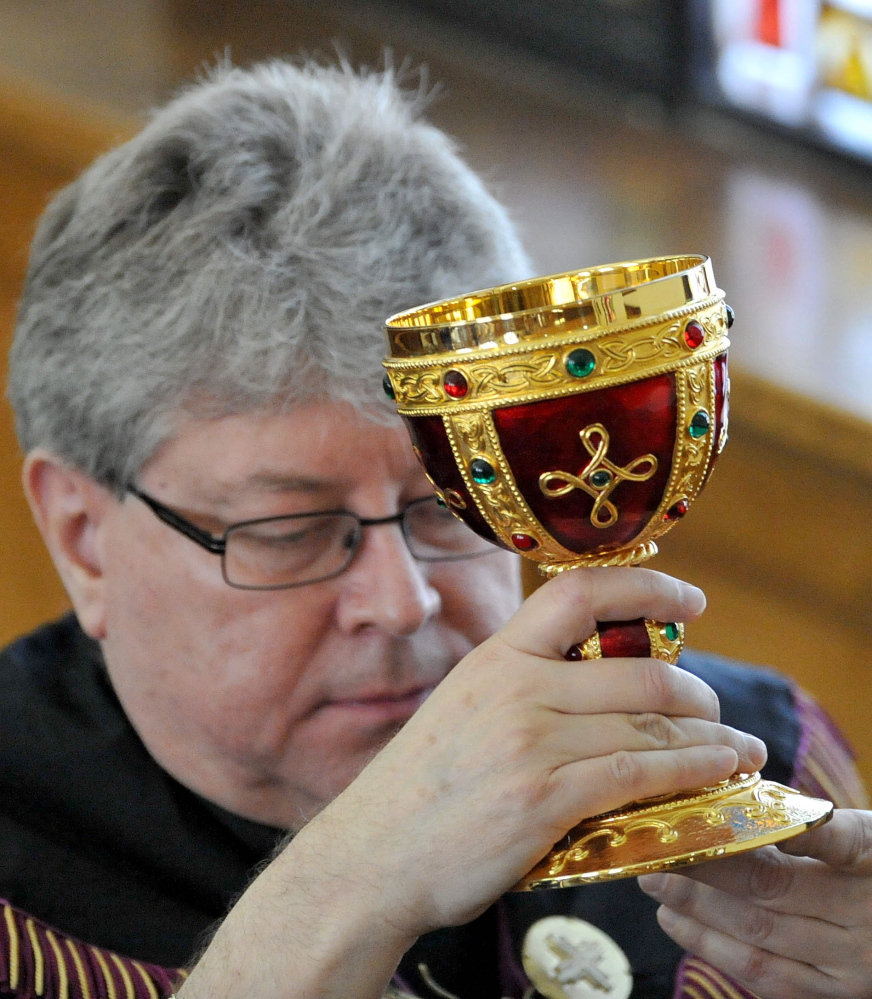 The Rev. Larry Jensen carries the Holy Chalice to the altar during the Signing of the Chalice ritual April 14 at St. Joseph's Maronite Church on Appleton Street in Waterville.