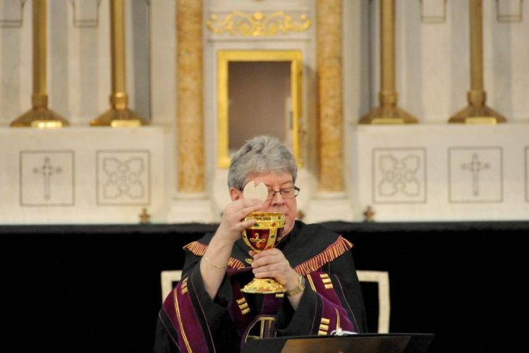 Staff file photo by Michael G. Seamans
The Rev. Larry Jensen puts Communion into the Holy Chalice on April 14 during the Signing of the Chalice ritual at St. Joseph's Maronite Church on Appleton Street in Waterville.