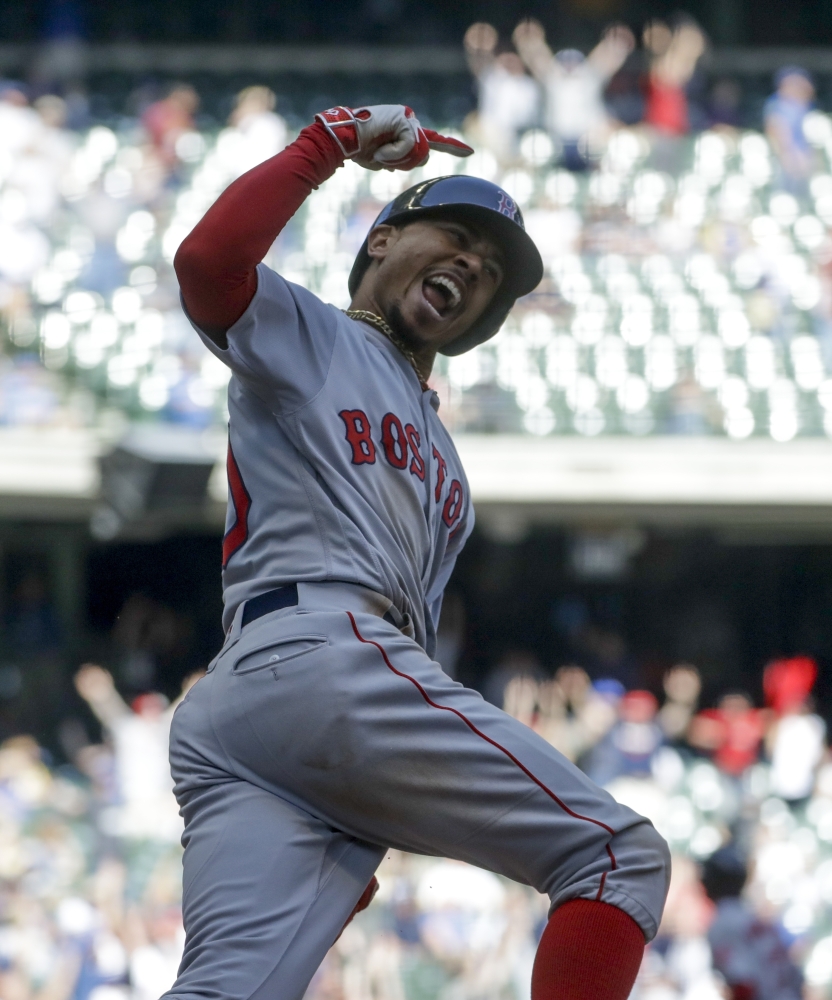 Boston outfielder Mookie Betts reacts as he rounds first after hitting a three-run home run in the ninth inning against the Brewers on Thursday in Milwaukee.
