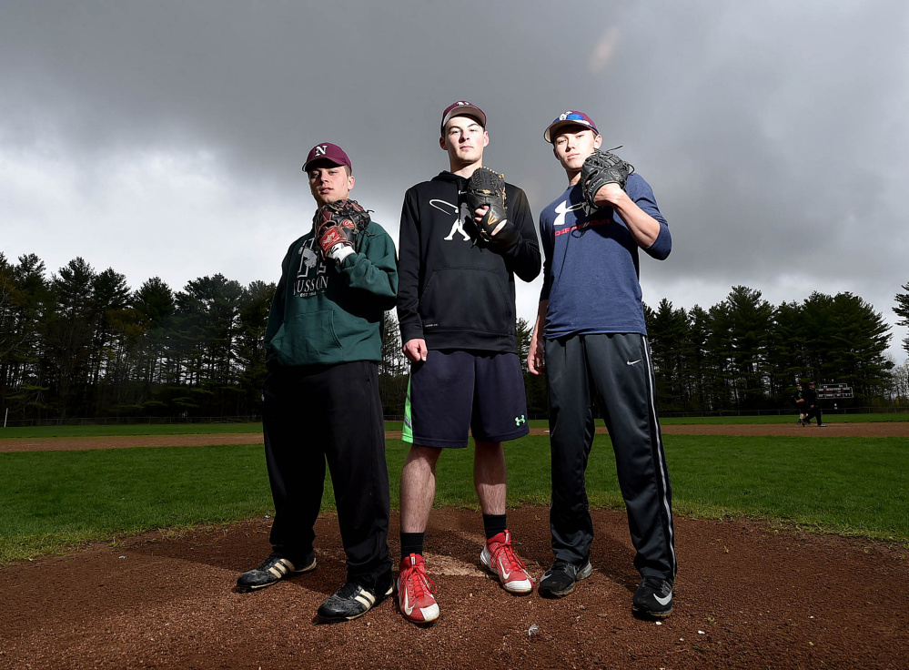 Nokomis pitchers Cody Rice, left, Matthew Dyer, center, and Joshua Perry stand on their mound during practice Thursday