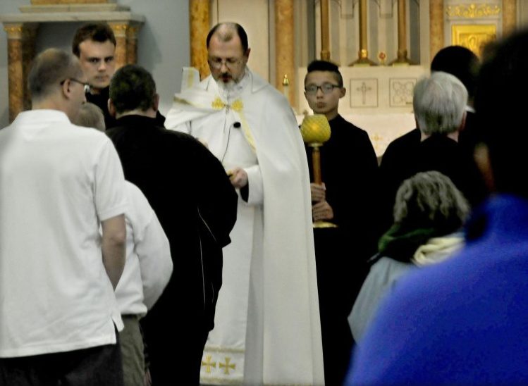The Rev. James Doran conducts a Mass for nearly 70 parishioners Sunday at the St. Joseph Maronite Catholic Church in Waterville. Doran has taken over since Rev. Larry Jenson was recently removed over allegations of sexual exploitation of a minor 15 years ago.