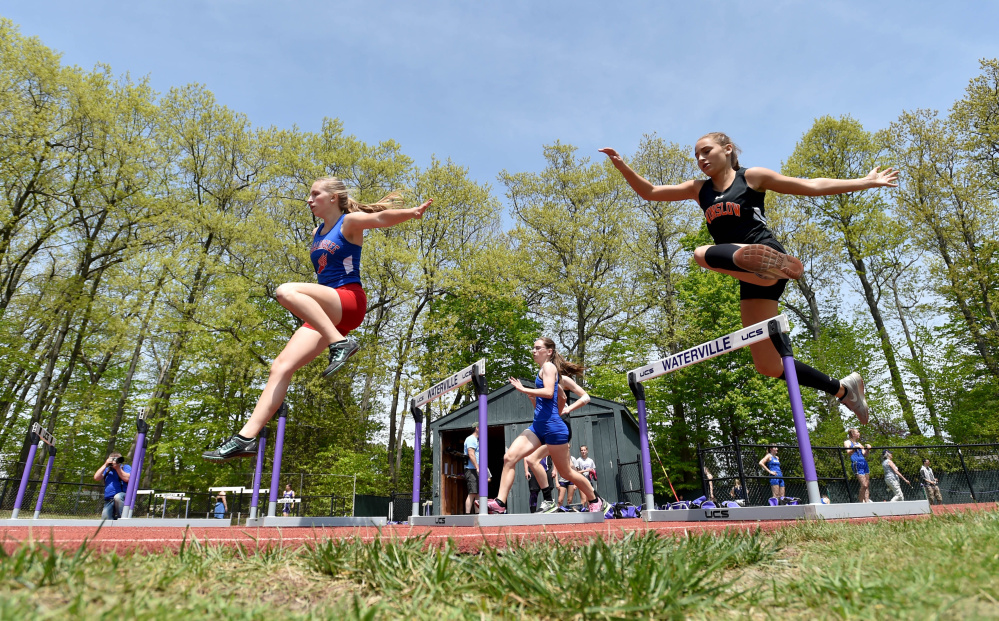 Athletes compete in the 300-meter hurdles during the annual Community Cup last year at Waterville Senior High School.