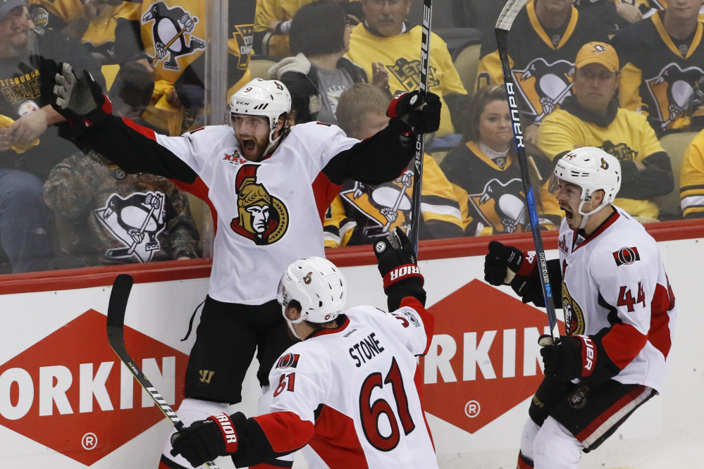 Ottawa Senators forward Bobby Ryan, left, celebrates with teammates Mark Stone (61) and Jean-Gabriel Pageau (44) after scoring the game-winning goal against the Pittsburgh Penguins in overtime of Game 1 of the Eastern Conference final.