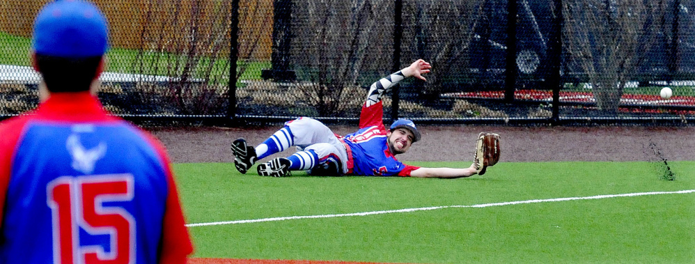 Messalonskee's Noah Tuttle slides to try and catch a ball during a game against Lawrence on Monday at Colby College.