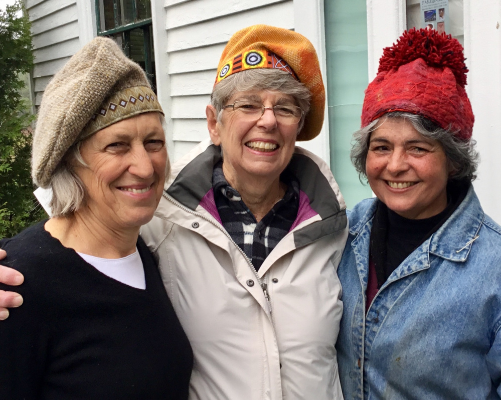 Stable Gallery artists, from left, Polly Smith, Mary Hall and Roz Welsh model hats created by Susan Perrine".