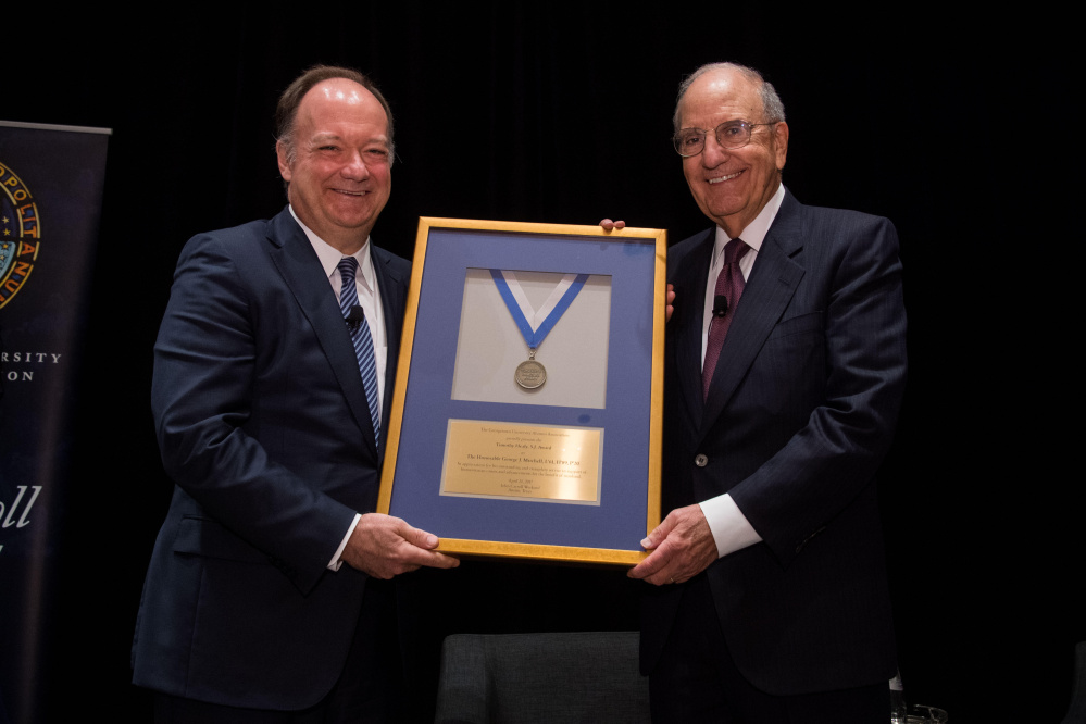 Georgetown University President John J. DeGioia, left, presents a special Timothy S. Healy, S.J. Award to former U.S. Sen. George J. Mitchell Jr., D-Maine, or his exemplary public service in support of society and humanitarian causes.