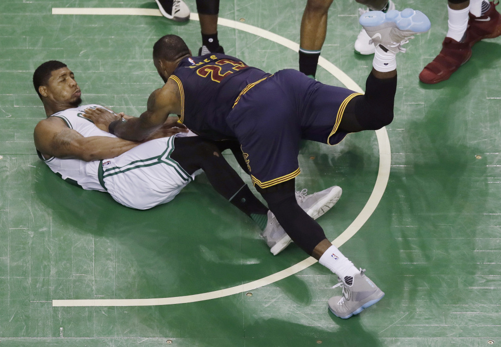 Cleveland forward LeBron James (23) falls to the floor with Boston guard Marcus Smart during the second quarter of Game 1 of the Eastern Conference finals Wednesday.