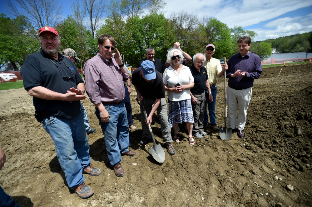 Mike Willey digs his shovel into the earth as members of the Oakland town council and gazebo committee break ground at the Messalonskee Lake boat launch for a new gazebo for community use on Friday.