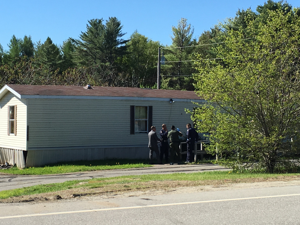 Authorities gather Saturday morning outside the Belgrade home where one person was killed and one was injured in an officer-involved shooting the previous night.