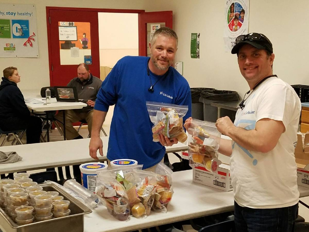 U.S. Cellular associates Kirk Fongemie, left, and Gaylon Wilkens recently helped the Boys & Girls Club of Greater Waterville on its Weekend Backpack Initiative.