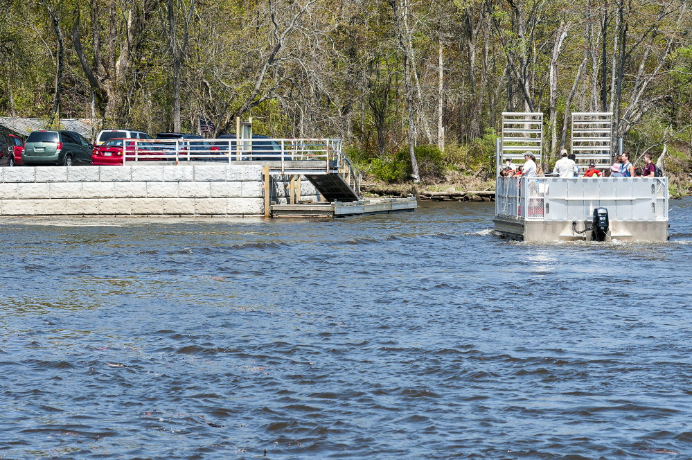 Swan Island Ferry carries a group of home-school students back to the new docking area from a visit to the island Wednesday on the shore of Kennebec River in Richmond.