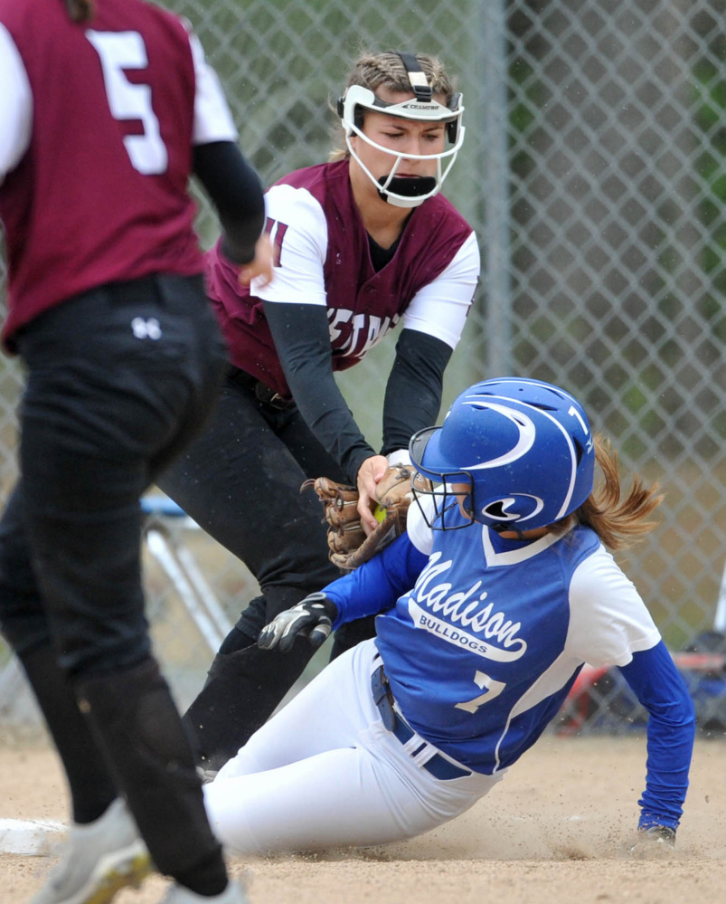 Madison Area Memorial High School's Sydney LeBlanc (7) slides safely into third base under the tag from Monmouth Academy's Hannah Anderson (11) in Madison on Thursday.