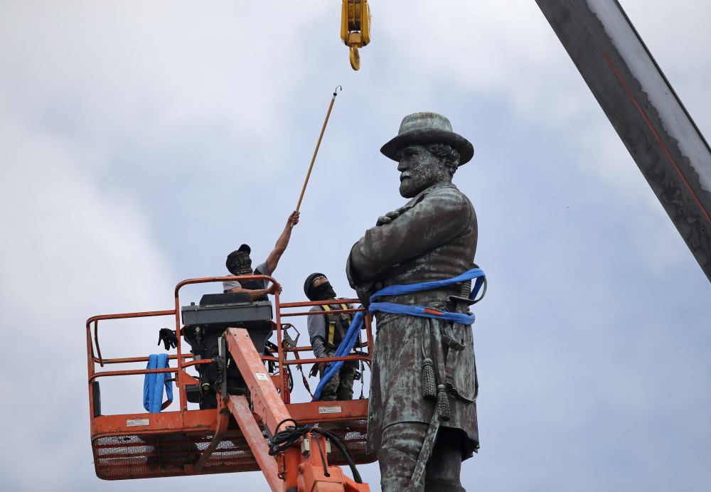 Workers prepare to take down the statue of former Confederate general Robert E. Lee, which stands over 100 feet tall, in Lee Circle in New Orleans, Friday, May 19, 2017. (AP Photo/Gerald Herbert)