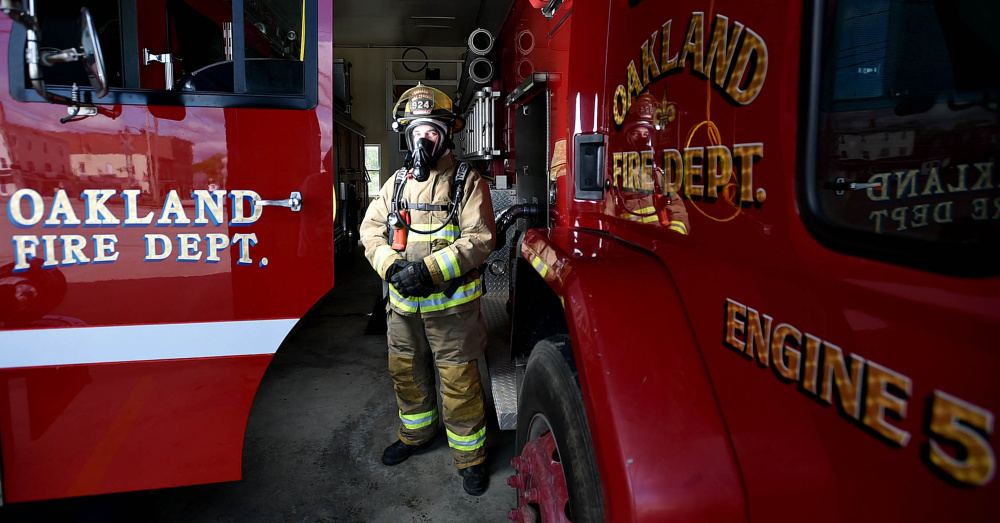 Oakland firefighter Randy Marshall stands wearing the current breathing apparatus that will soon be replaced in Oakland on Saturday.