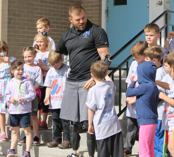 Travis Mills with kindergarten students at St. Michael School in Augusta.