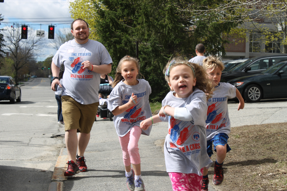 Johathan Irwin, left, with Kya Douin, Natalie Irwin and Eli Burnham during the St. Michael School and Travis Mills Walk-athon May 3, proceeds from the event will benefit the Travis Mills Foundation.