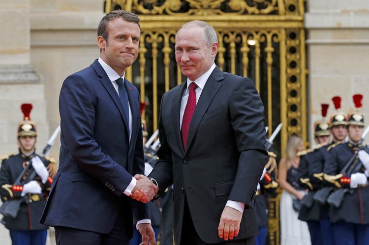 Russian President Vladimir Putin is welcomed by French President Emmanuel Macron at the Palace of Versailles, near Paris, Monday. Macron is the first Western leader to meet with Putin after the G7 Summit over the weekend where relations with Russia were a key part of the agenda.