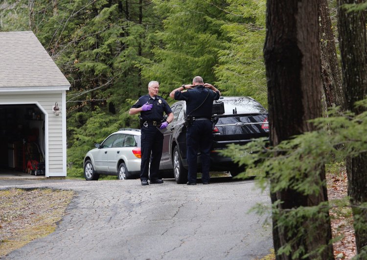 Falmouth Lt. John Kilbride, left, speaks with Officer Steve Hamilton as they investigate a shooting on Poplar Ridge Drive in Falmouth on Tuesday. 