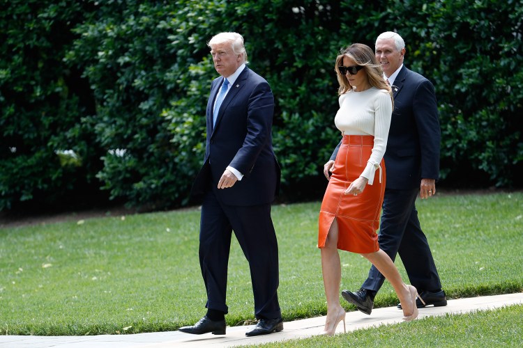 President Trump and first lady Melania Trump, escorted by Vice President Mike Pence, walk across the South Lawn of the White House in Washington on Friday before boarding Marine One for a short trip to Andrews Air Force Base, Md. Trump is leaving for his first foreign trip, visiting Saudi Arabia, Israel and the Vatican, and attending a pair of summits in Brussels and Sicily. 