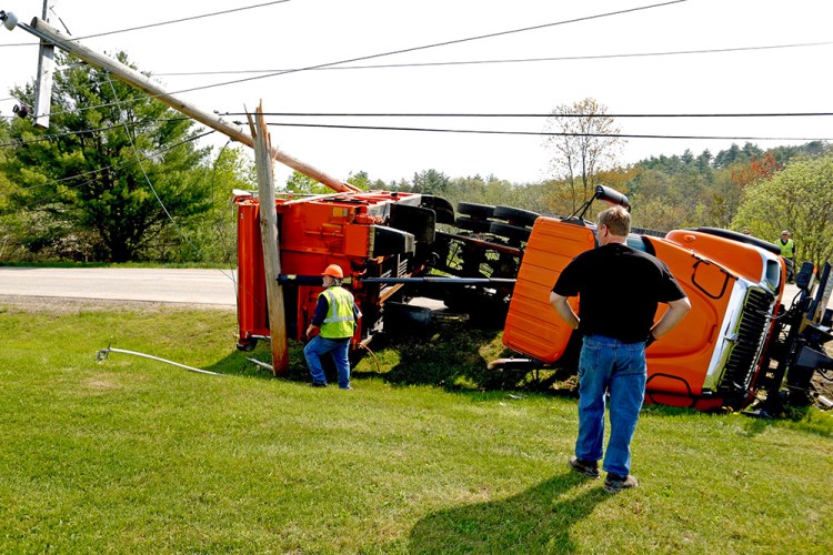 Don Roberts, left, of Westbrook public services, and Brian Beaulieu, driver for B&B Towing, are at the crash scene on Gorham Public Works Drive Thursday morning. 

