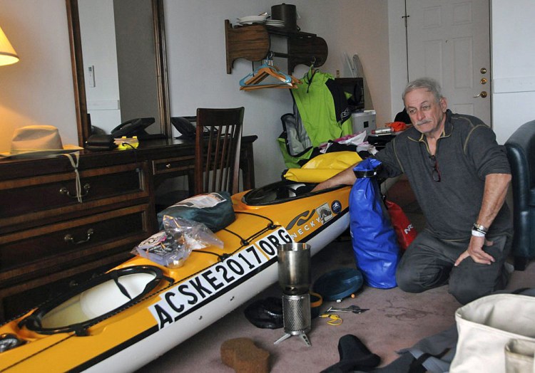 Joseph Mullin sits in his room Monday at the Motel East in Eastport with his sea kayak. Mullin's kayak flipped Sunday off Down East Maine and he had to be rescued by the Coast Guard. He plans to paddle down the East Coast to Key West, Fla., to raise money and awareness for efforts to prevent suicide by veterans. 