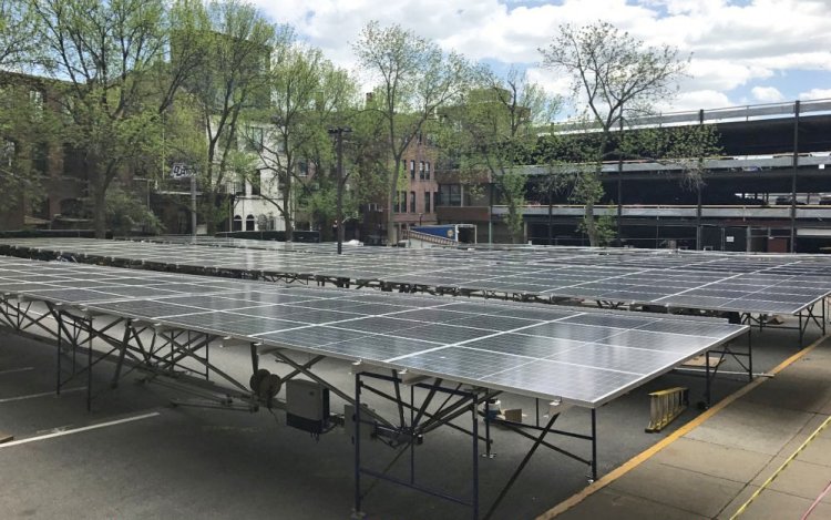 A solar array sits in a parking lot next to the Fore Street parking garage where it was later installed. 