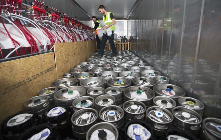 Davey Blackmon, left, and Jared Maruhnic, of Marshall Wharf Brewing Co., encase keg couplers in bubble wrap within the Maine Beer Box prior to being shipped to Iceland for a beer festival in June 2017. The custom-fabricated container boasts more than 70 kegs. 