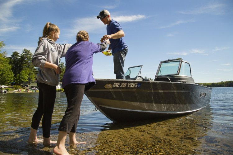 Nicole Smith and her daughter Emily, 12, hand supplies to Nicole's husband, Heath Smith, as they prepare for a fishing outing Sunday on Little Ossipee Lake in East Waterboro. Some boaters who were out Sunday said the recent accidents have made them more vigilant.