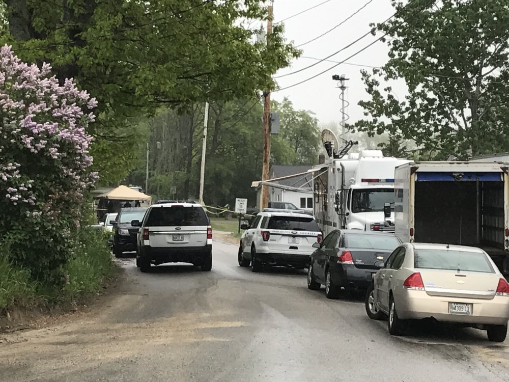 Police vehicles converge at Chad Dionne's home at Old Alfred Road in Arundel on May 29.