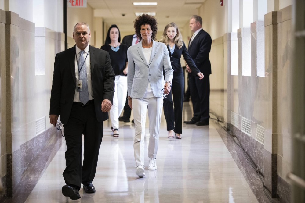 Andrea Constand, center, walks to the courtroom during Bill Cosby's sexual assault trial at the Montgomery County Courthouse in Norristown, Pa., on Tuesday. Cosby is accused of drugging and sexually assaulting Constand at his home outside Philadelphia in 2004.