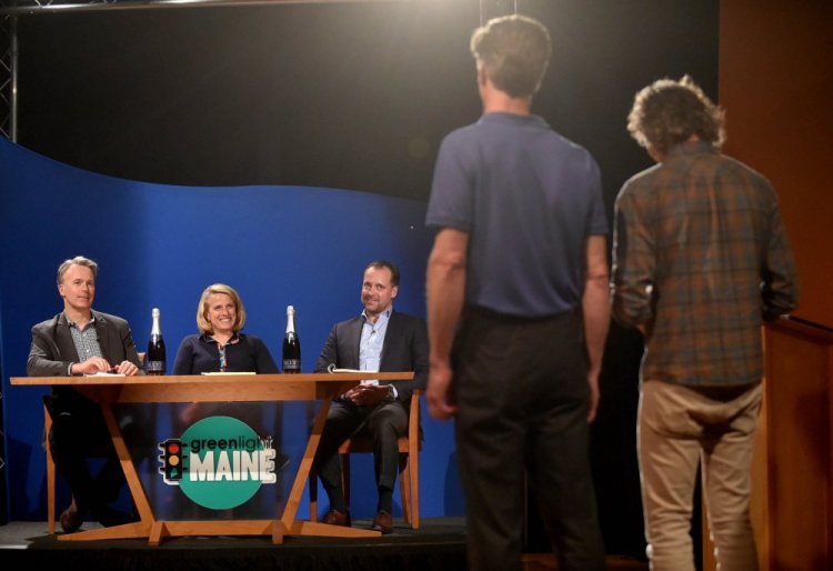 "Greenlight Maine" judges, from left, Michael Burgmaie of Whipstitch, Betsy Peters, chief revenue officer at Better Lessons, and Michael Petit of JMH Capital listen to a business pitch Tuesday from Bluet sparkling blueberry wine owners Eric Martin, far right, and Michael Terrien, second from left in foreground, during the recording of "Greenlight Maine" at Thomas College in Waterville.