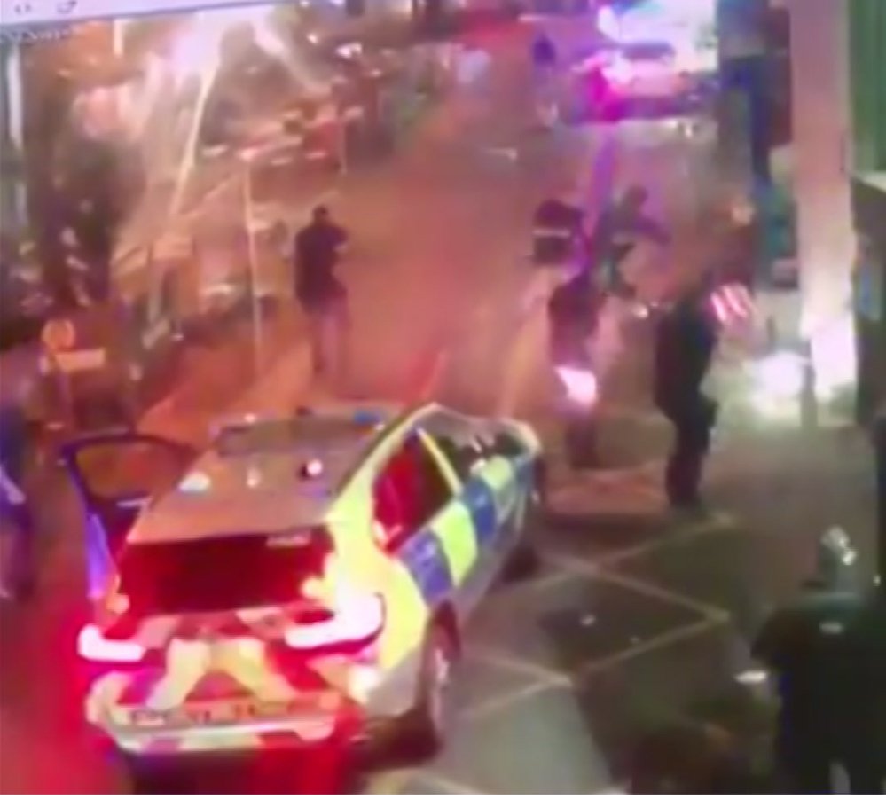 In this image taken from video which emerged on social media, shows police as they surround an attacker on the ground at right, during the  attack in Borough Market in southeast London on June 3. The dramatic video footage has been released showing the moment that armed police swooped into a busy London market area to stop an attack in just eight minutes.
