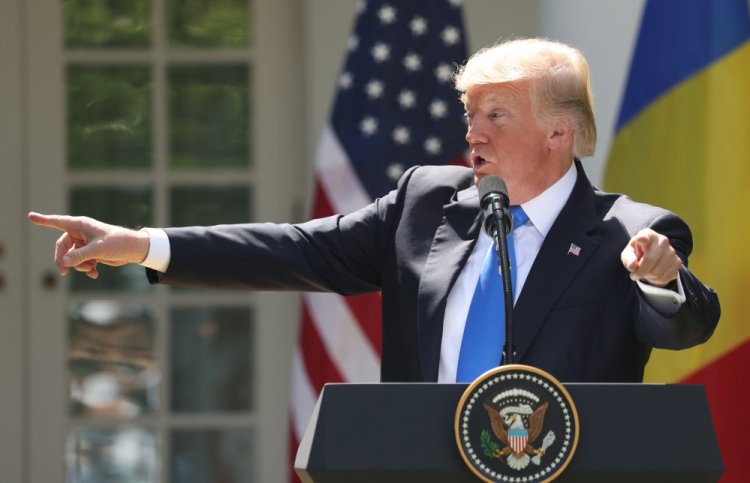 President Trump, accompanied by Romanian President Klaus Werner Iohannis, speaks at a news conference in the Rose Garden at the White House on Friday.