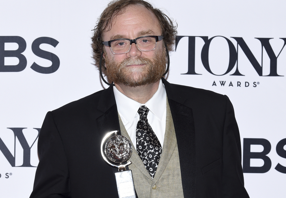 Christopher Akerlind holds his Tony Award for Best Lighting Design of a Play.