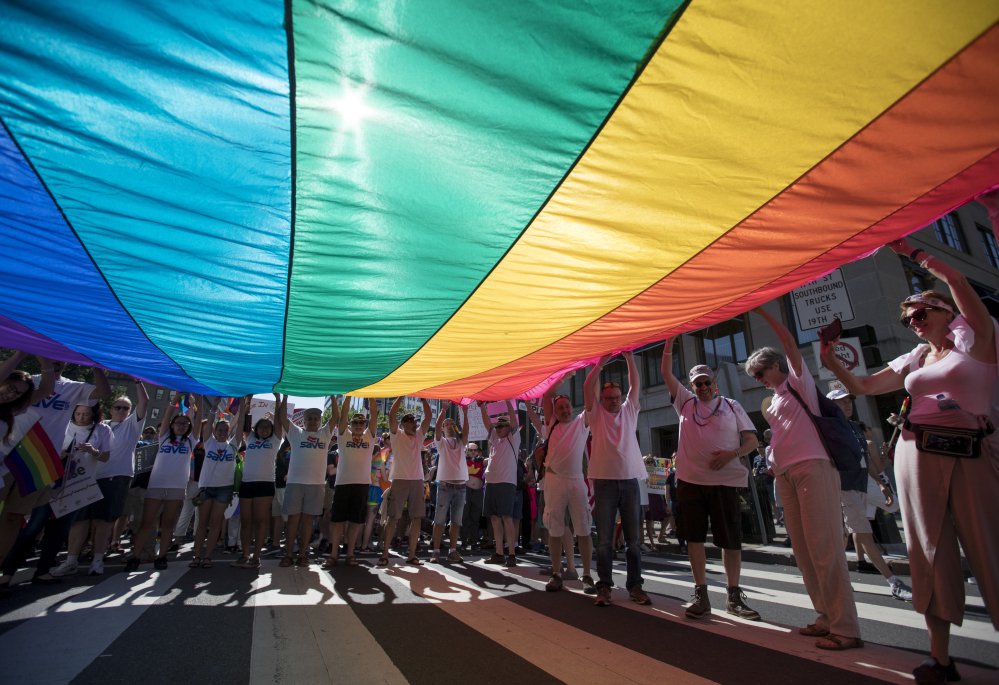 Marchers unfurl a huge rainbow flag as they prepare to march in the Equality March for Unity and Pride in Washington in 2017. Thousands paraded past the White House.