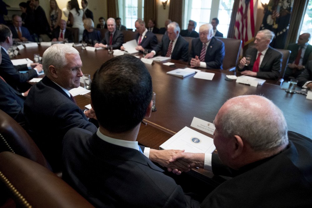 Vice President Pence, left, shakes hands with Agriculture Secretary Sonny Perdue during President Trump's Cabinet meeting Monday at the White House. The meeting came as the White House struggles to advance its agenda.