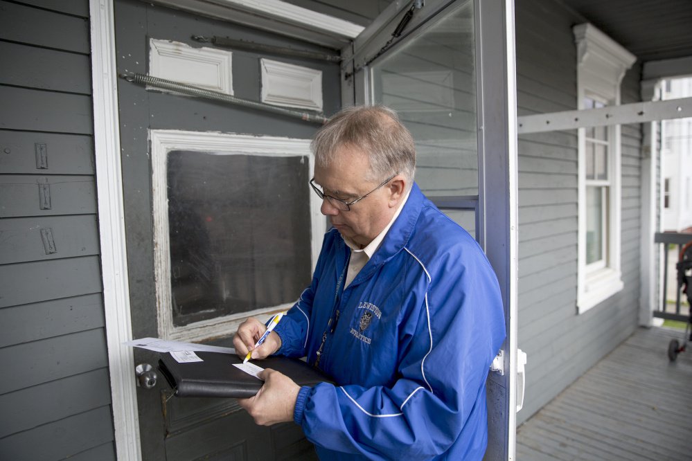 Truancy officer Butch Pratt writes down his number and a note to leave on the door of an apartment where he hoped to discuss a student's absenteeism. Pratt said most parents do call him back if they aren't home.