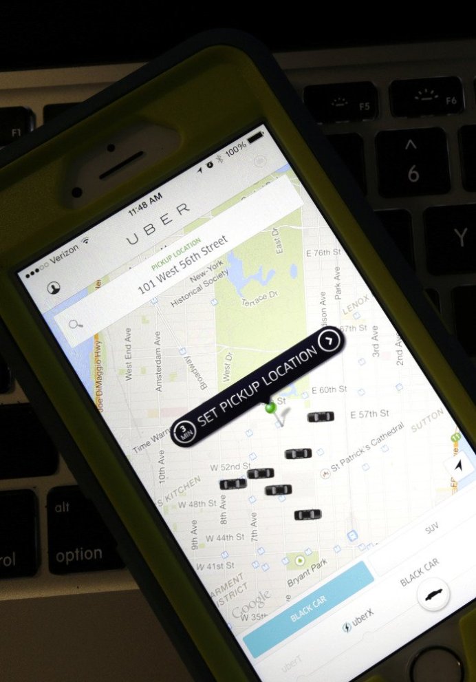 A smartphone displays Uber car availability in New York. Uber is catching up to its rival Lyft by enabling riders to tip its U.S. drivers with a tap on its ride-hailing app.