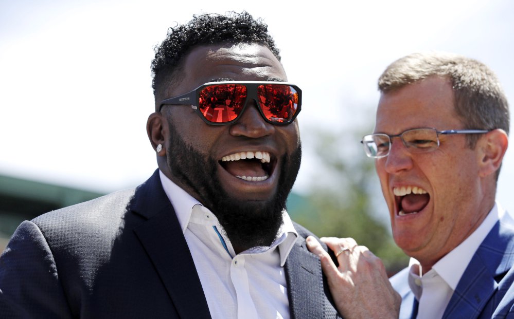 Retired Boston Red Sox designated hitter David Ortiz, left, shares a laugh with team president Sam Kennedy during a gathering where part of Yawkey Way was renamed David Ortiz Drive on Thursday outside Fenway Park in Boston. Ortiz's No. 34 will be retired in a ceremony prior to Friday night's game.